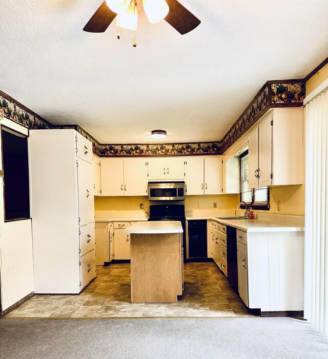  - kitchen with stainless steel microwave, dishwasher, a sink, a ceiling fan, and light countertops