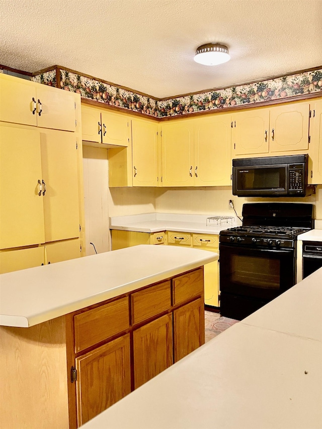 kitchen featuring light countertops, a textured ceiling, and black appliances