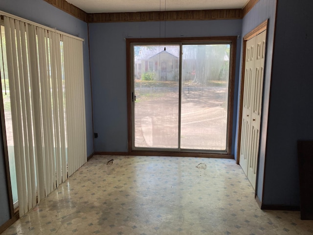 unfurnished dining area with baseboards