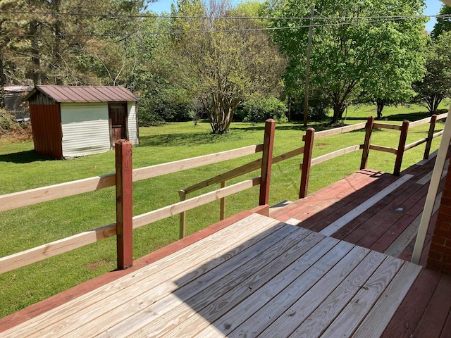 wooden terrace with an outdoor structure, a storage shed, and a lawn