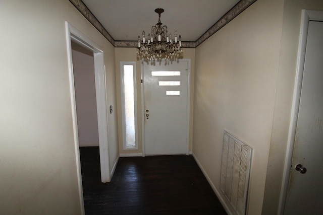  - entryway with a chandelier, dark wood-style flooring, and baseboards
