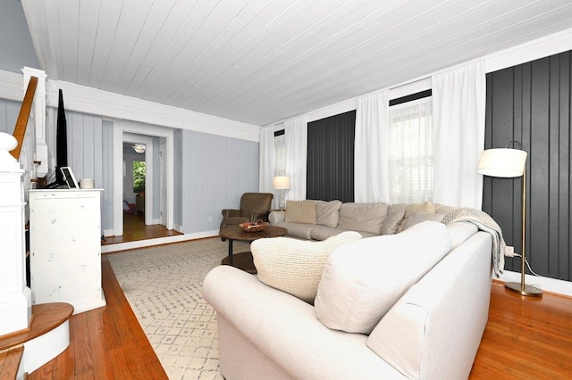 living room featuring plenty of natural light, wood-type flooring, and wooden ceiling