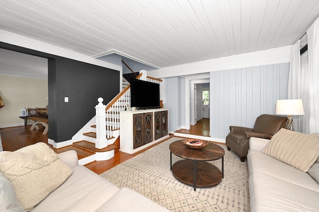 living room featuring hardwood / wood-style flooring, wooden walls, and wood ceiling