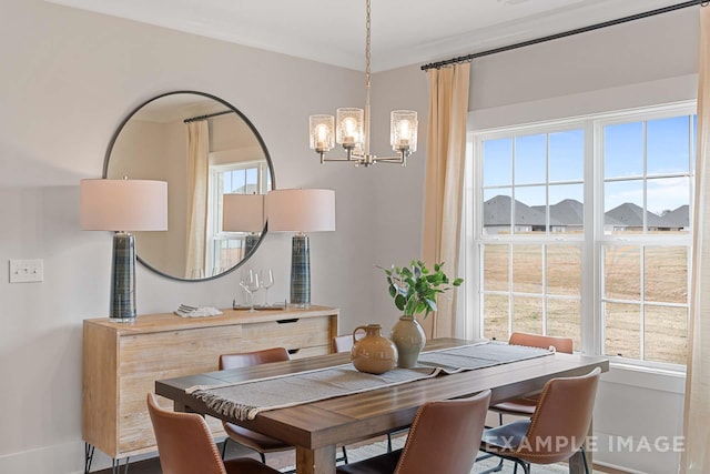 dining space featuring an inviting chandelier and ornamental molding