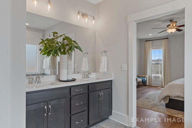 bathroom with hardwood / wood-style floors, vanity, and ceiling fan