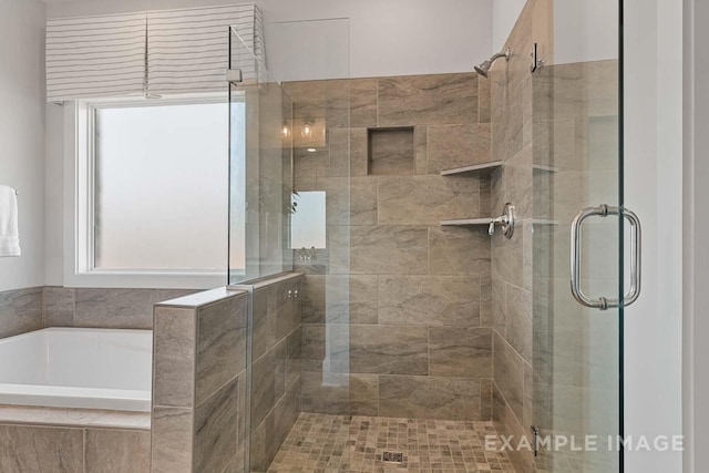 bathroom featuring shower with separate bathtub