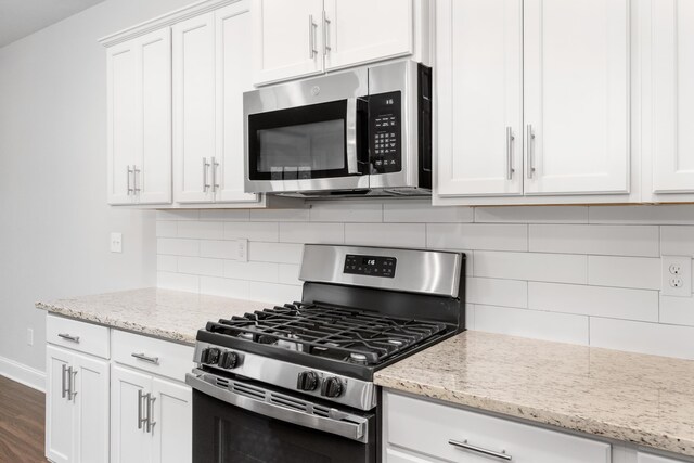 kitchen with custom exhaust hood, a center island with sink, crown molding, hanging light fixtures, and stainless steel appliances