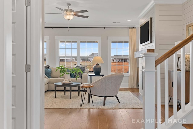 living room with hardwood / wood-style flooring, ceiling fan, and a healthy amount of sunlight