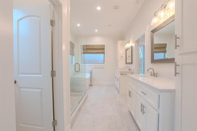 bathroom featuring ornamental molding, vanity, and shower with separate bathtub