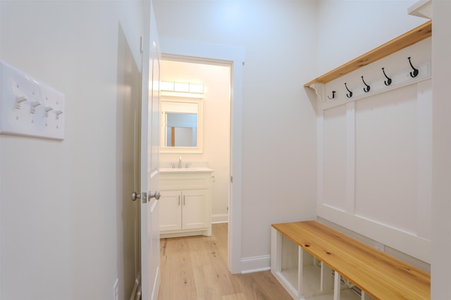 mudroom featuring light hardwood / wood-style flooring and sink