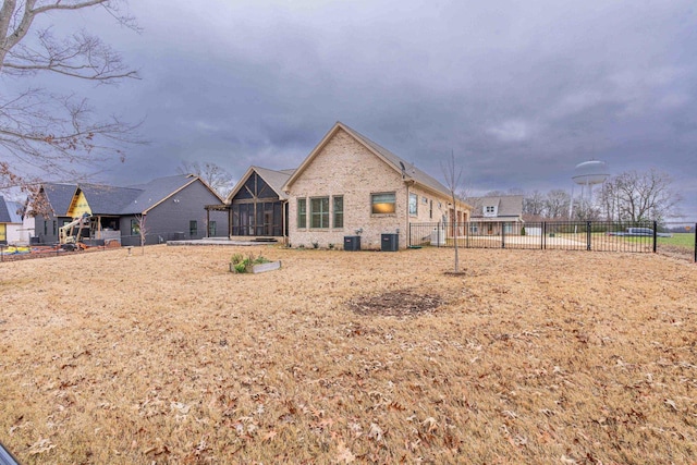 rear view of house featuring cooling unit