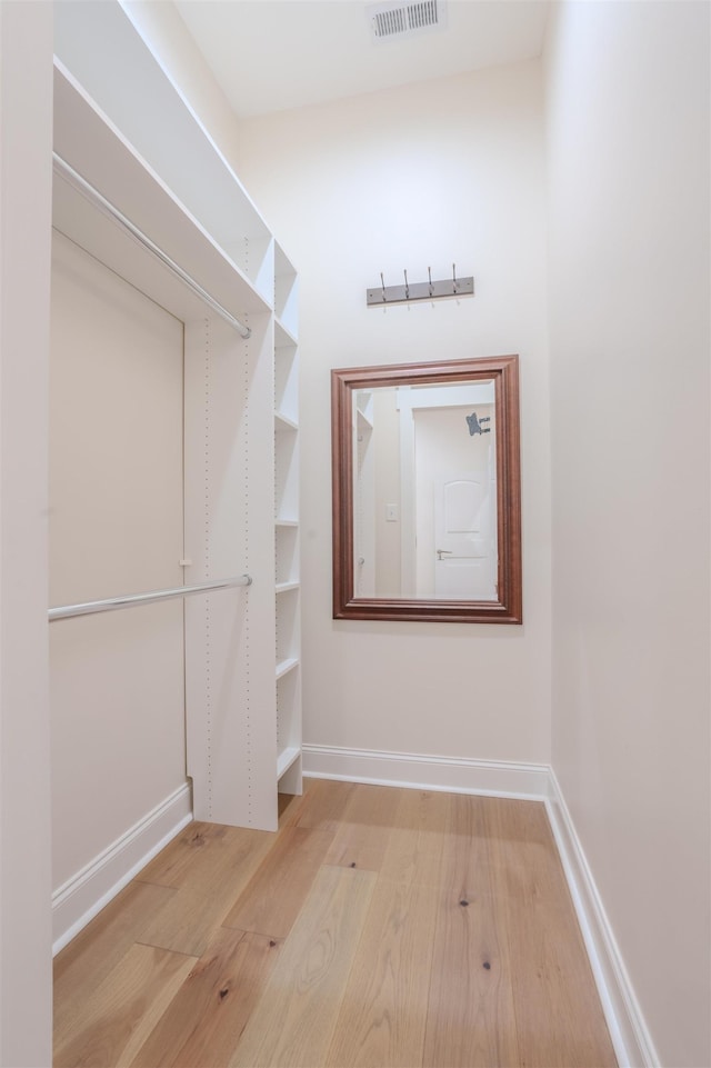 spacious closet with light hardwood / wood-style flooring