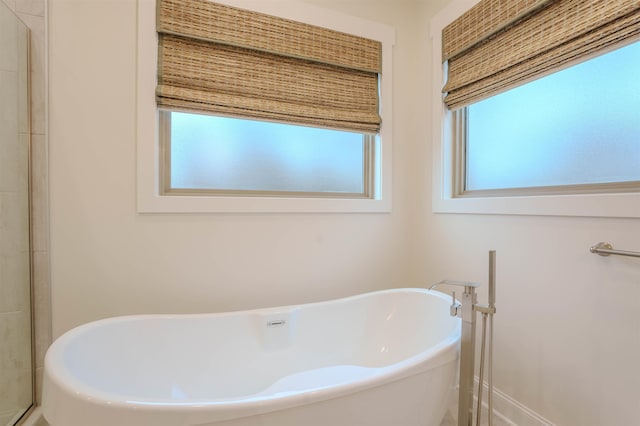 bathroom featuring a tub to relax in