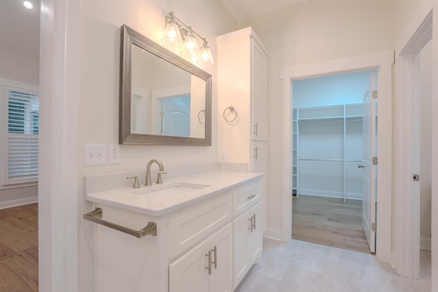 bathroom featuring vanity and ornamental molding