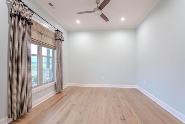 empty room with ceiling fan, light hardwood / wood-style floors, and crown molding