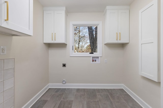 laundry room featuring washer hookup, hookup for an electric dryer, cabinet space, and baseboards