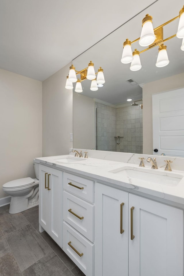 bathroom with a stall shower, visible vents, a sink, and double vanity