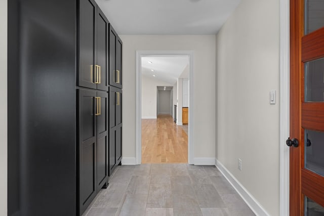 hall featuring baseboards