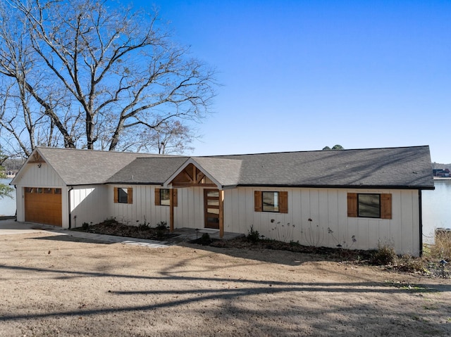 modern farmhouse with driveway and an attached garage