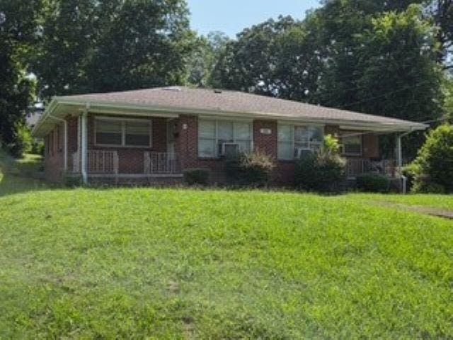  - view of front of property featuring covered porch and a front yard