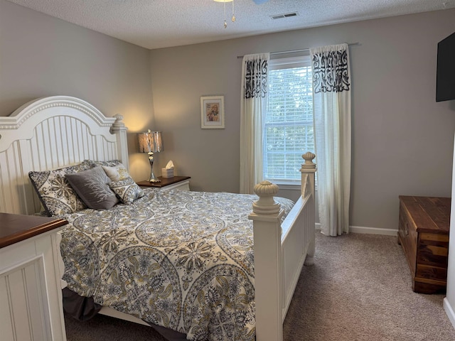 bedroom with carpet flooring and a textured ceiling