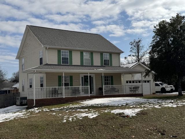 view of front of property with covered porch, a garage, and cooling unit