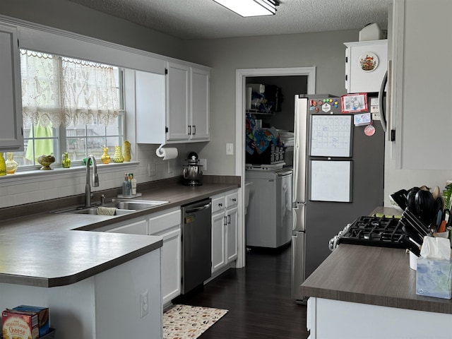 kitchen with white cabinets, dishwasher, sink, and a textured ceiling