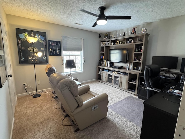 carpeted living room featuring a textured ceiling and ceiling fan