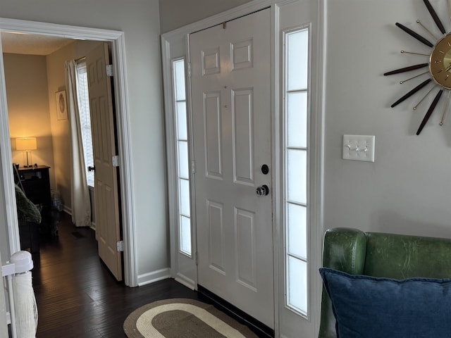 entryway with dark hardwood / wood-style flooring