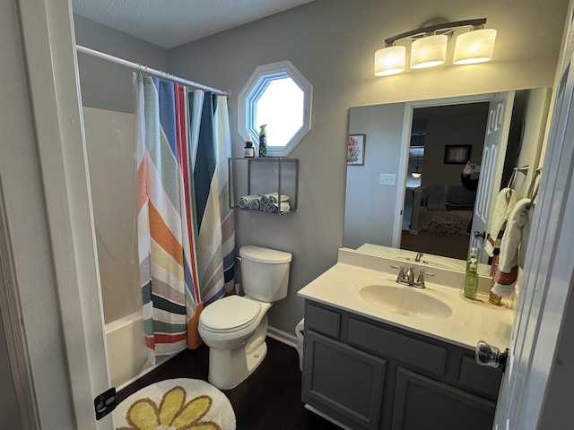 full bathroom with vanity, shower / bath combination with curtain, and toilet