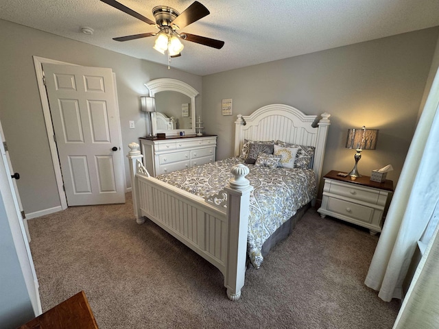 carpeted bedroom with ceiling fan and a textured ceiling