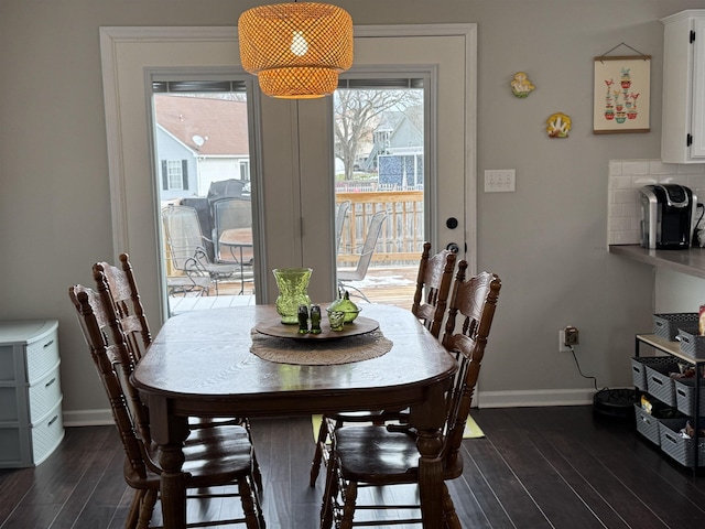 dining space with dark hardwood / wood-style floors