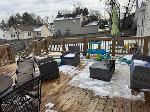 snow covered deck featuring an outdoor hangout area and a playground