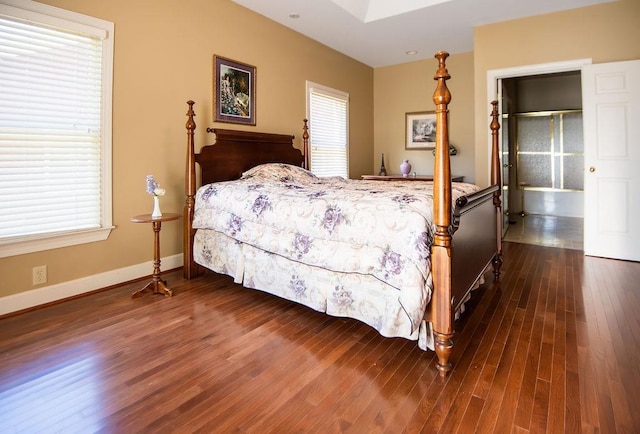  - bedroom featuring dark wood-style flooring and baseboards