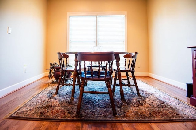  - dining room with baseboards and wood finished floors