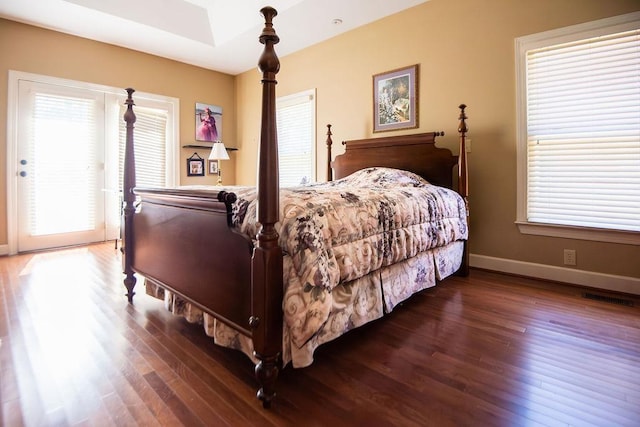  - bedroom with wood finished floors and baseboards