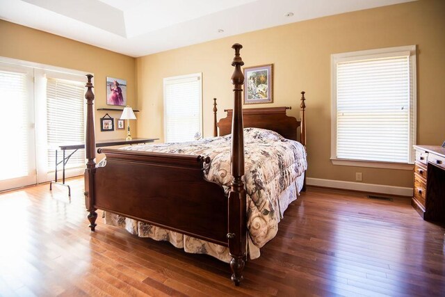  - bedroom with wood finished floors and baseboards