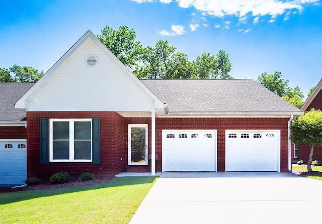  - view of front facade with an attached garage, driveway, brick siding, a front yard, and a shingled roof