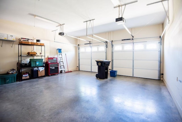  - garage featuring a garage door opener and baseboards