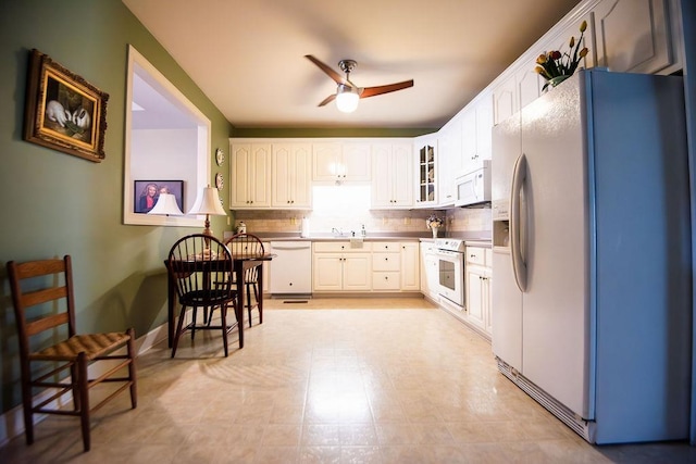  - kitchen with white appliances, ceiling fan, glass insert cabinets, backsplash, and white cabinets
