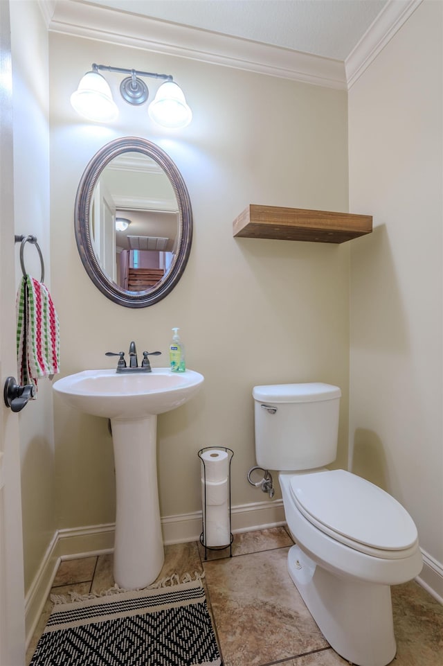 bathroom featuring ornamental molding, toilet, tile patterned flooring, and sink