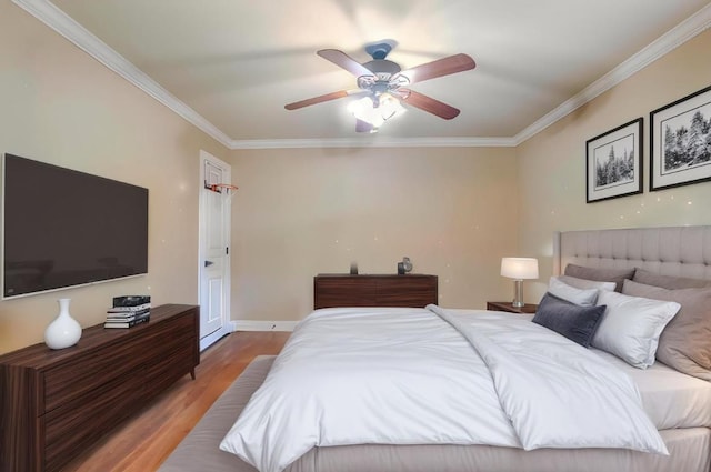  - bedroom with crown molding, wood finished floors, and ceiling fan