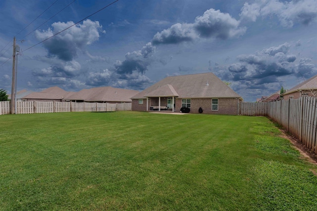  - back of house with a fenced backyard and a patio area