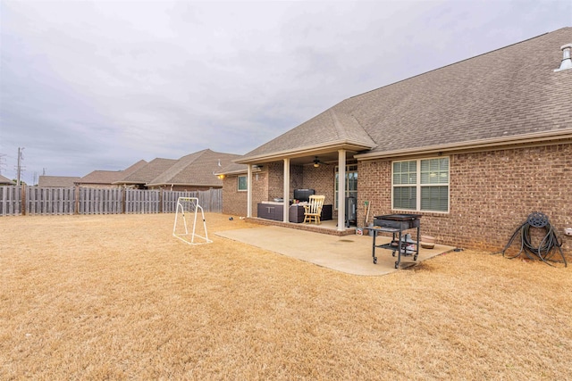 view of yard with ceiling fan and a patio