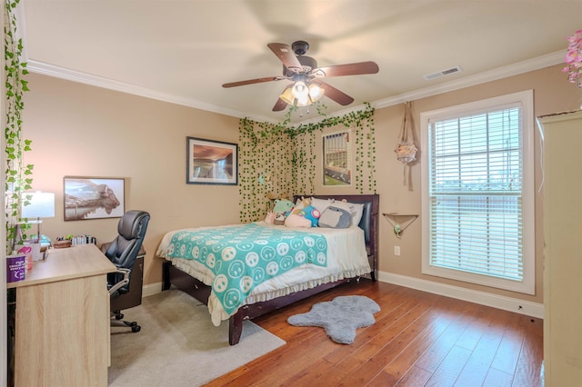 bedroom with ceiling fan, ornamental molding, and hardwood / wood-style floors