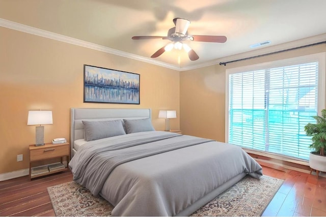  - bedroom with ornamental molding, dark wood-type flooring, and a ceiling fan