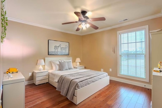  - bedroom featuring wood-type flooring, ornamental molding, and a ceiling fan