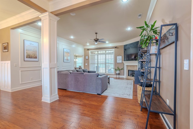 living room with ornamental molding, dark hardwood / wood-style floors, ceiling fan, and ornate columns