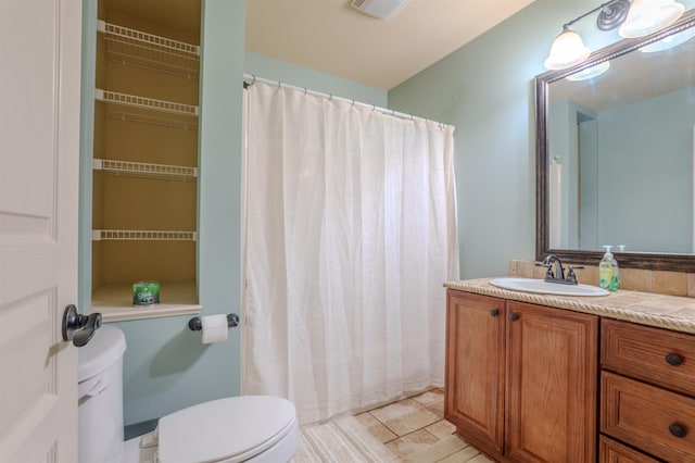 bathroom with vanity and toilet