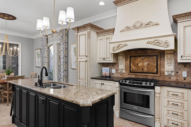 kitchen featuring sink, a notable chandelier, stainless steel range with gas stovetop, a kitchen island with sink, and custom exhaust hood